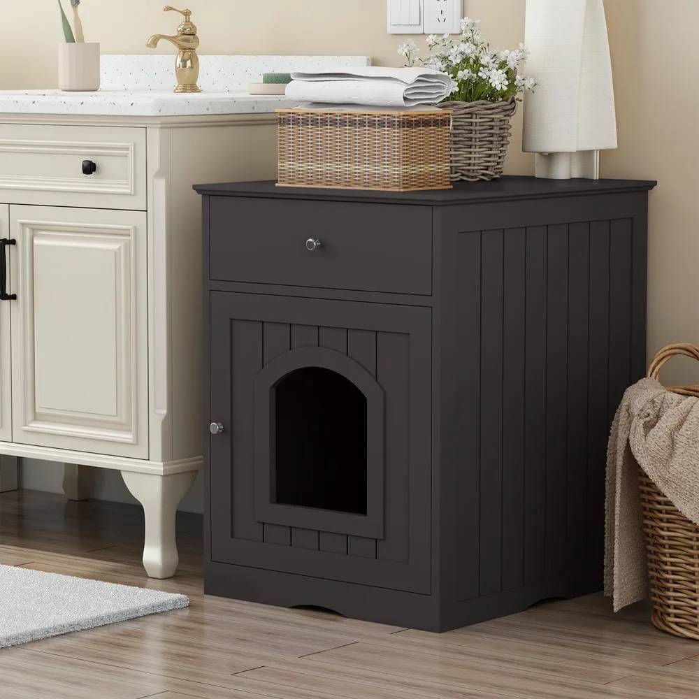 Closed wood-finish cabinet hiding the litter pan with a plant on top