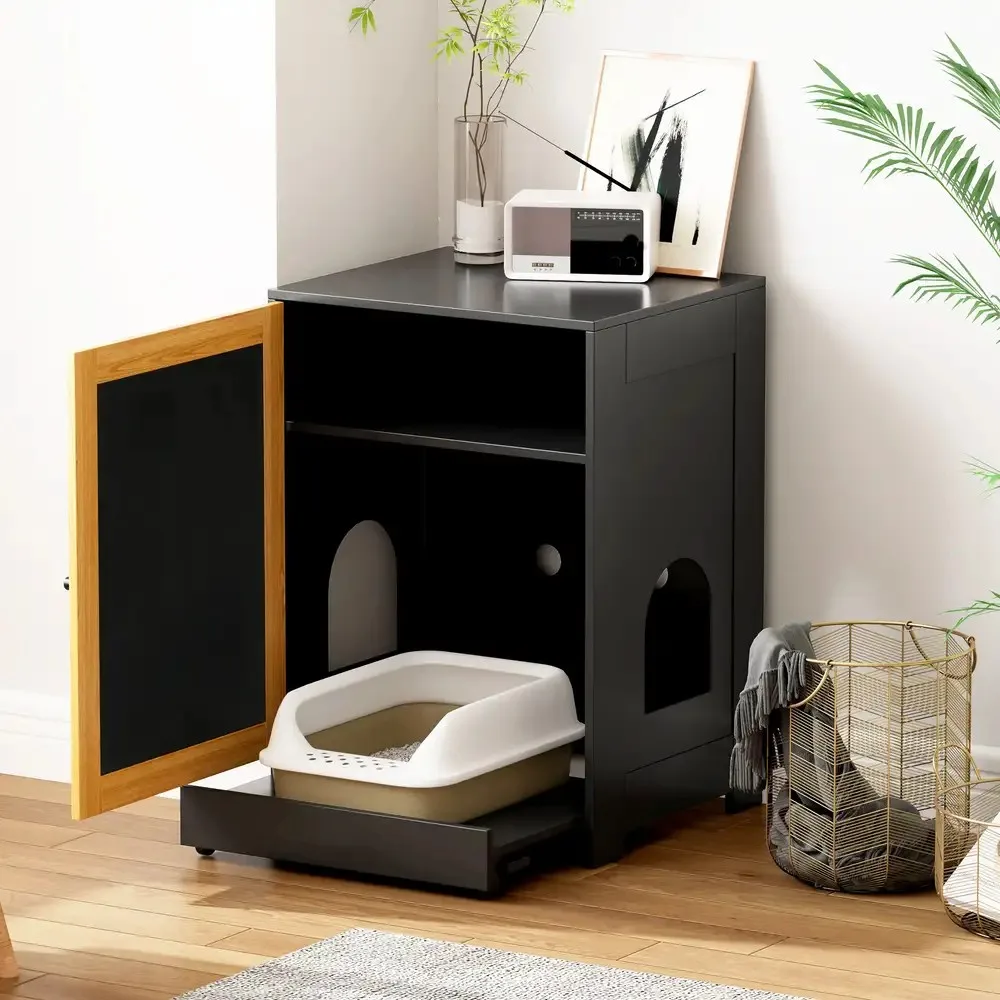 Open cat litter box enclosure showing the litter pan inside a styled room
