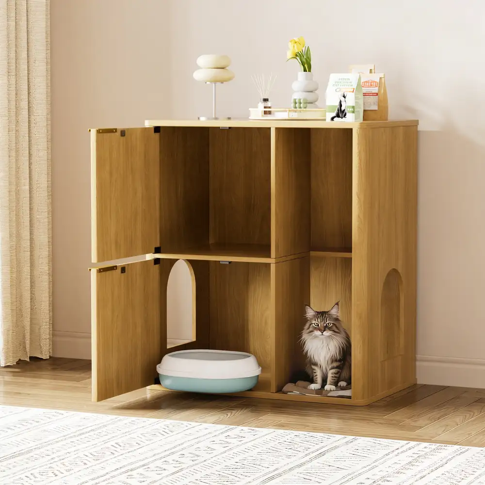 Open cat litter box cabinet with long-haired cat resting inside next to the litter pan